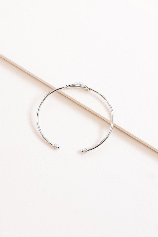 Infinity cuff bracelet on a white background.