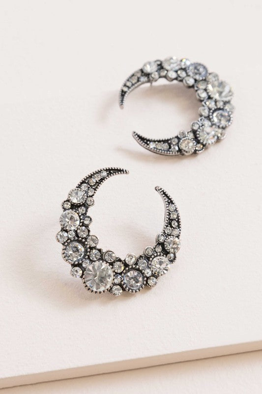 A pair of Moon Lit Night Earrings with rhinestones on a white background.