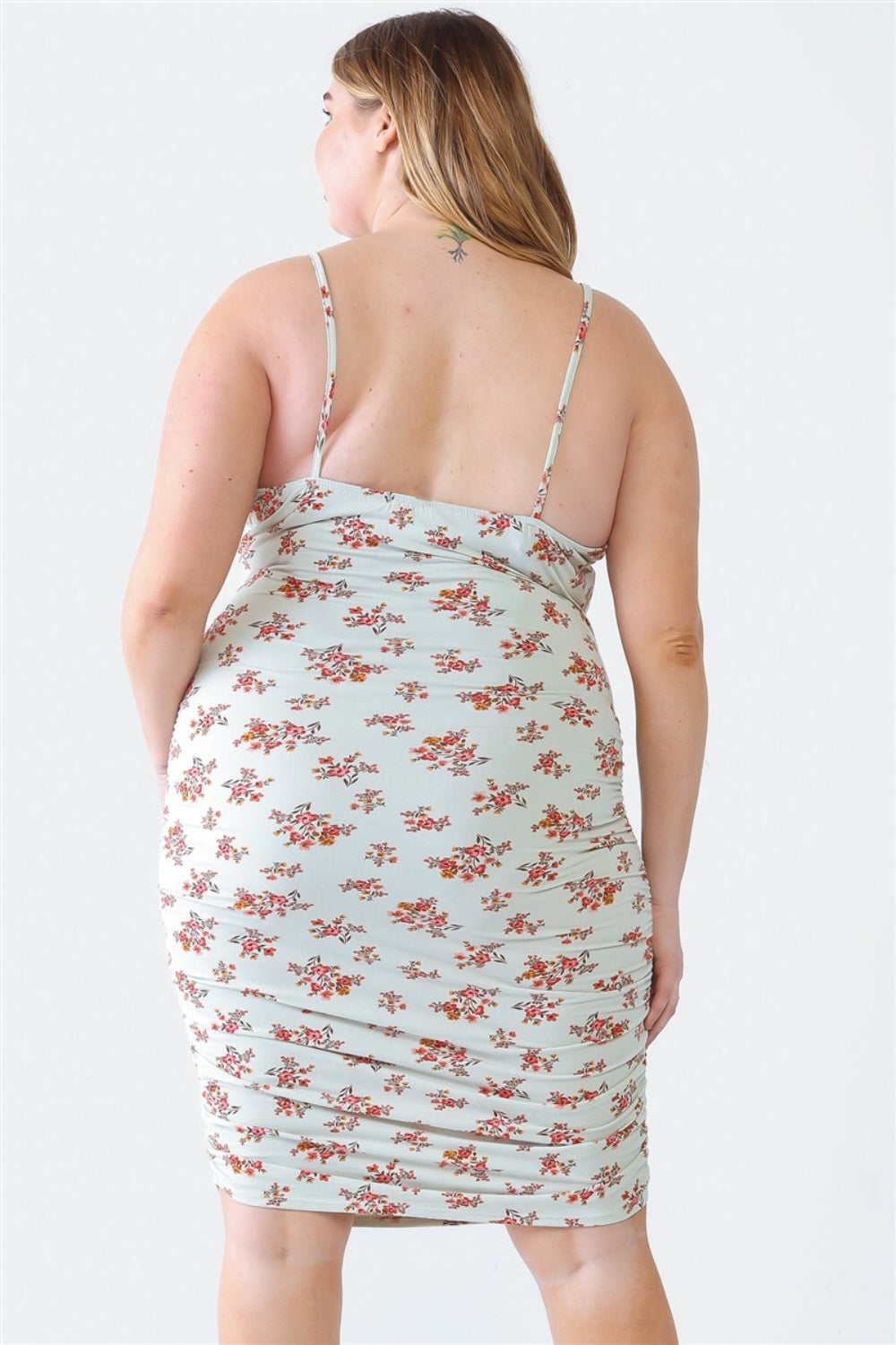 A woman stands against a white background wearing a Blue Leopard Plus Size Ruched Floral Square Neck Cami Dress with strappy high-heeled sandals, perfect for a summer day out.