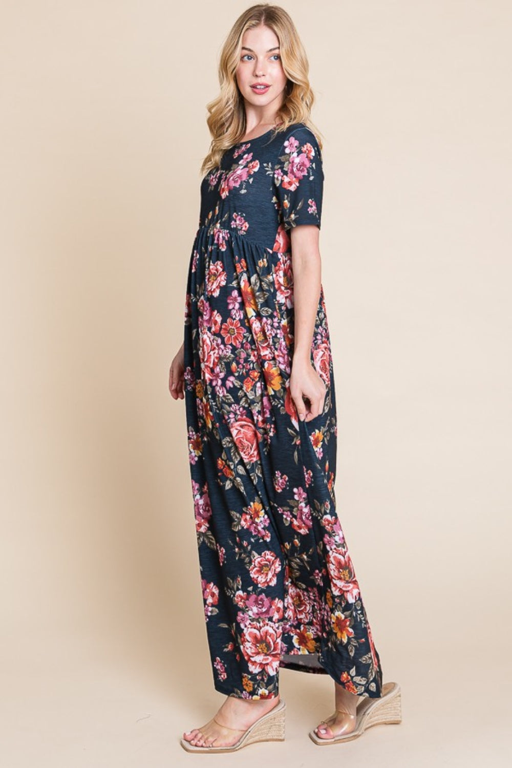 A person wearing the elegant BOMBOM Floral Short Sleeve Maxi Dress, featuring a long and flowy silhouette, stands against a plain background.