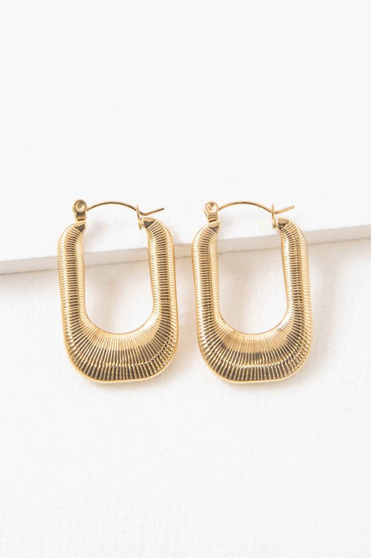 Nomad Hoop Earrings with a grooved texture on a white background.