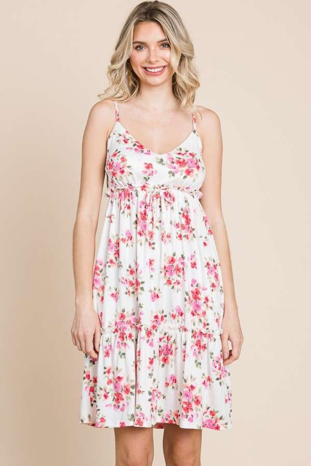 A person wearing the Culture Code Full Size Floral Frill Cami Dress, featuring pink floral patterns, stands against a plain background.