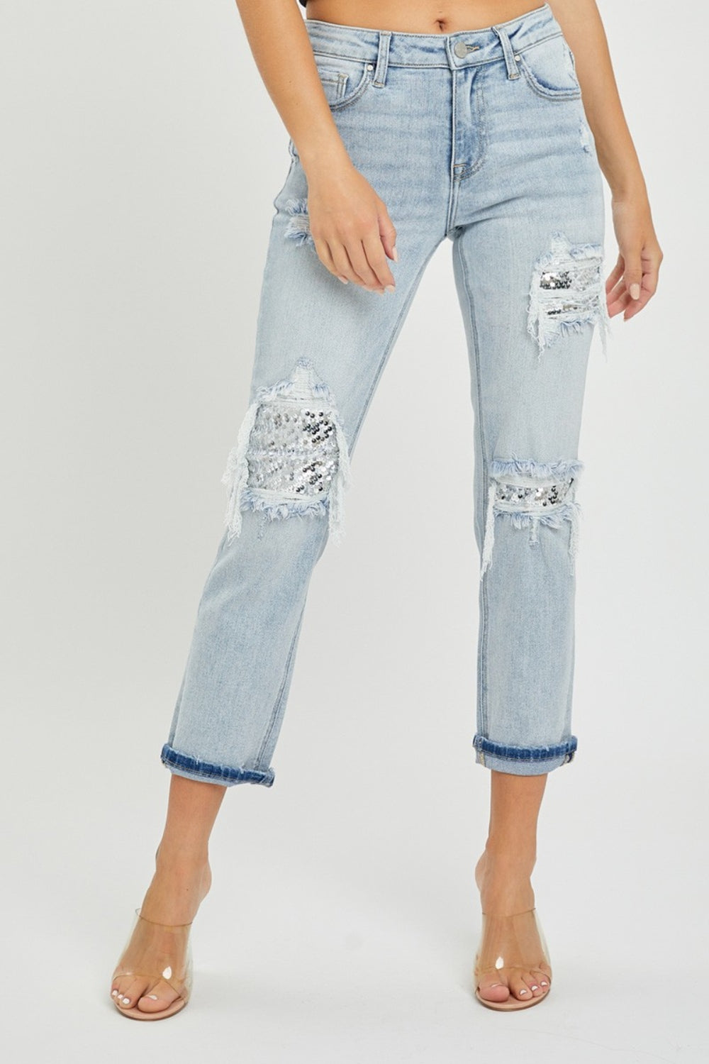 Person wearing RISEN Mid-Rise Sequin Patched Jeans and clear high-heeled sandals, against a plain background.