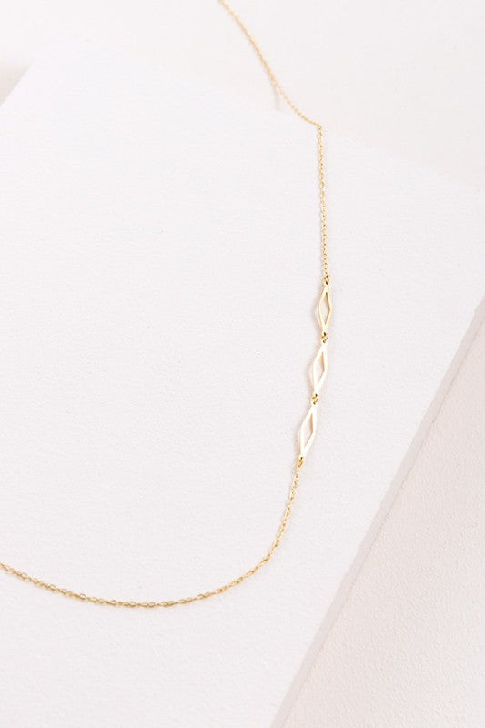 A delicate Diamonds Are Forever Necklace displayed on a white surface.