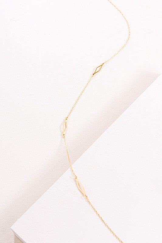 A delicate Diamonds Are Forever Necklace displayed on a white surface.