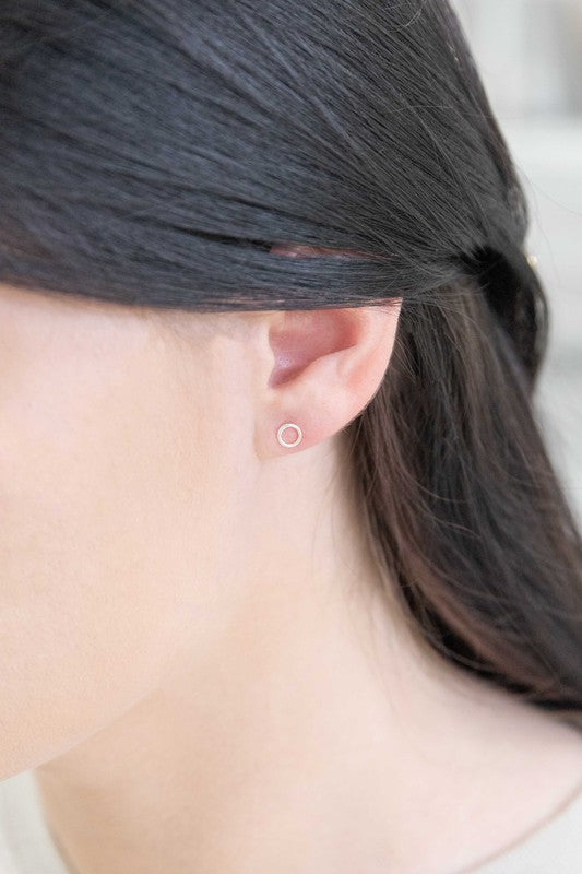 A sterling silver stud earring and a Dueling Ring Mismatched Earrings 14K, mismatched, placed side by side on a plain white background.