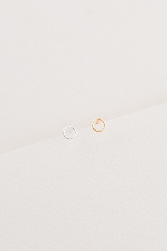 A sterling silver stud earring and a Dueling Ring Mismatched Earrings 14K, mismatched, placed side by side on a plain white background.
