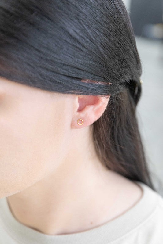 A sterling silver stud earring and a Dueling Ring Mismatched Earrings 14K, mismatched, placed side by side on a plain white background.