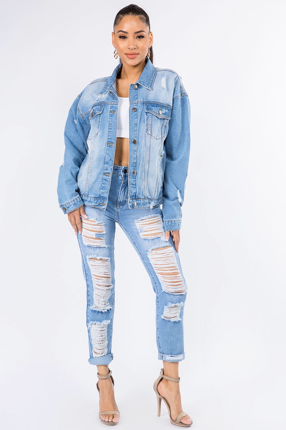 A person wearing the American Bazi Graphic Distressed Long Sleeve Denim Jacket and matching ripped jeans over a white top, standing against a plain white background.