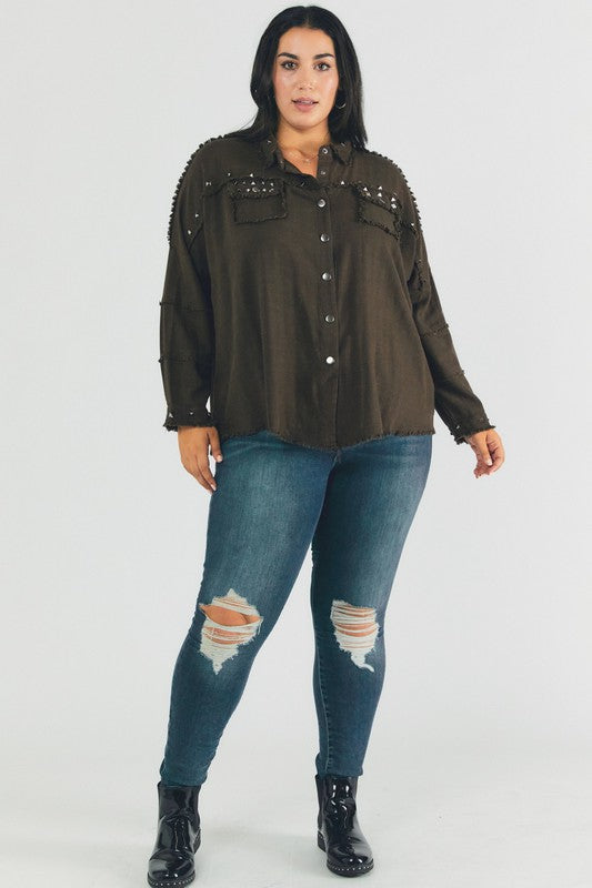 A person with dark hair wearing a Plus Distressed Hem Button Down Oversize Shirt and jeans stands against a light background, embodying casual comfort.