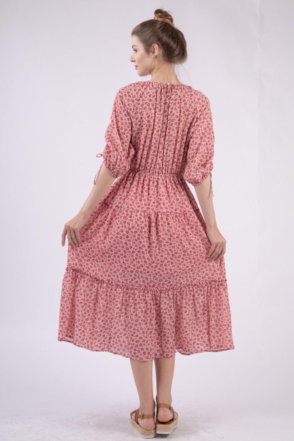 A woman wearing the VERY J Floral Round Neck Tiered Midi Dress and sandals poses gracefully against a plain white background.