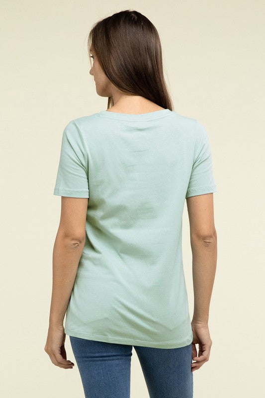 A person with long hair is standing and wearing a light blue Cotton V-Neck Short Sleeve T-Shirt and black pants.