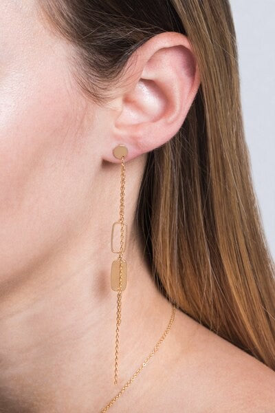 Absolutely Alluring Dangle Earrings with geometric shapes on a pink background.