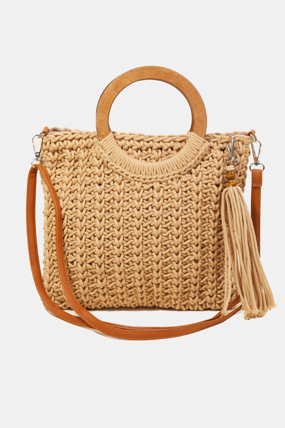 The Fame Crochet Knit Convertible Tote Bag includes a cream-colored design with round wooden handles and a matching tassel accent.