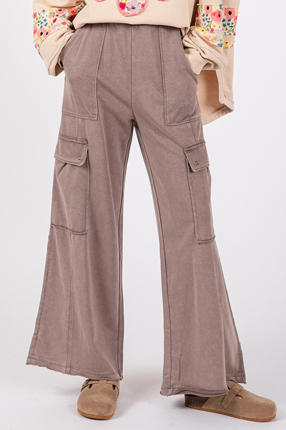 A person wearing SAGE + FIG Knit Terry Mineral Wash Wide Leg Pants in brown and beige shoes stands against a plain background.