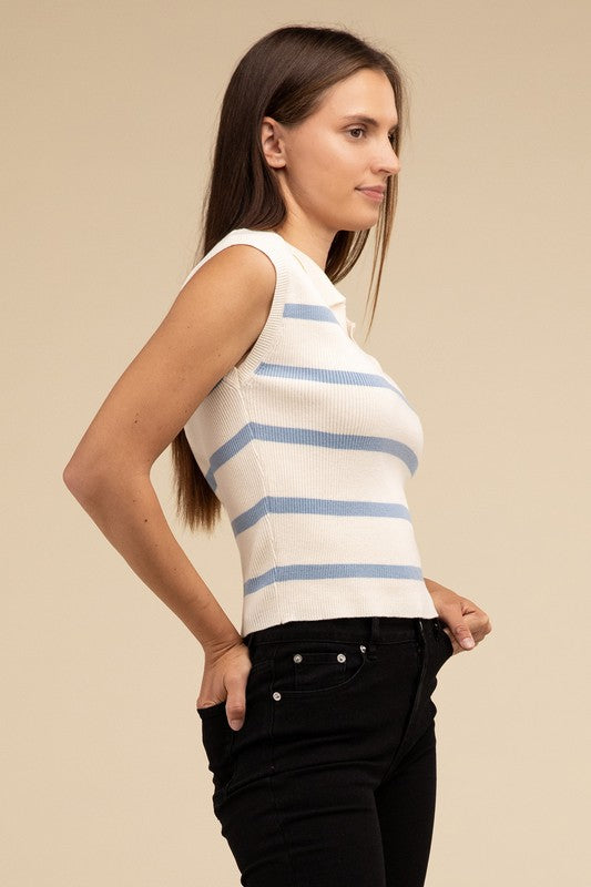 A person sits on a floral couch wearing a Striped Polo Vest with a fitted bodice and a light blue skirt, with their hair tied up.