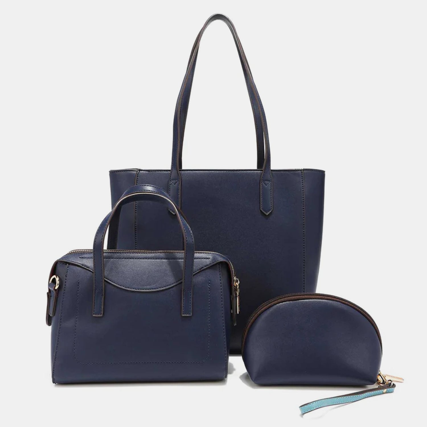 The Nicole Lee USA 3-Piece Color Block Handbag Set is a stylish collection that includes three blue and white vegan leather bags with black straps: a versatile tote bag, a chic small handbag, and an elegant round wristlet with a strap.