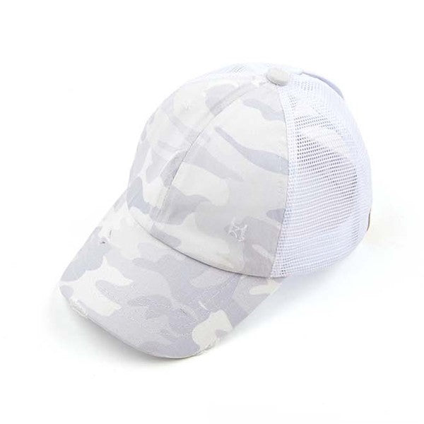 Woman wearing a black mesh CC Camo Criss-Cross Ponytail Cap with an adjustable velcro closure.