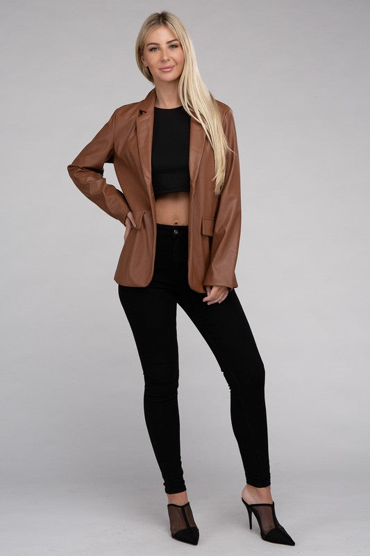 A person with long blonde hair wears the Sleek Pu Leather Blazer with Front Closure over a black top, standing against a plain background.