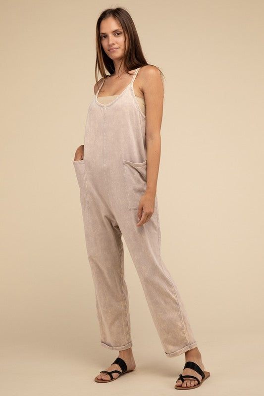 Woman standing and posing in a studio, wearing casual comfort style green Washed Spaghetti Straps Overalls with Pockets and sandals.