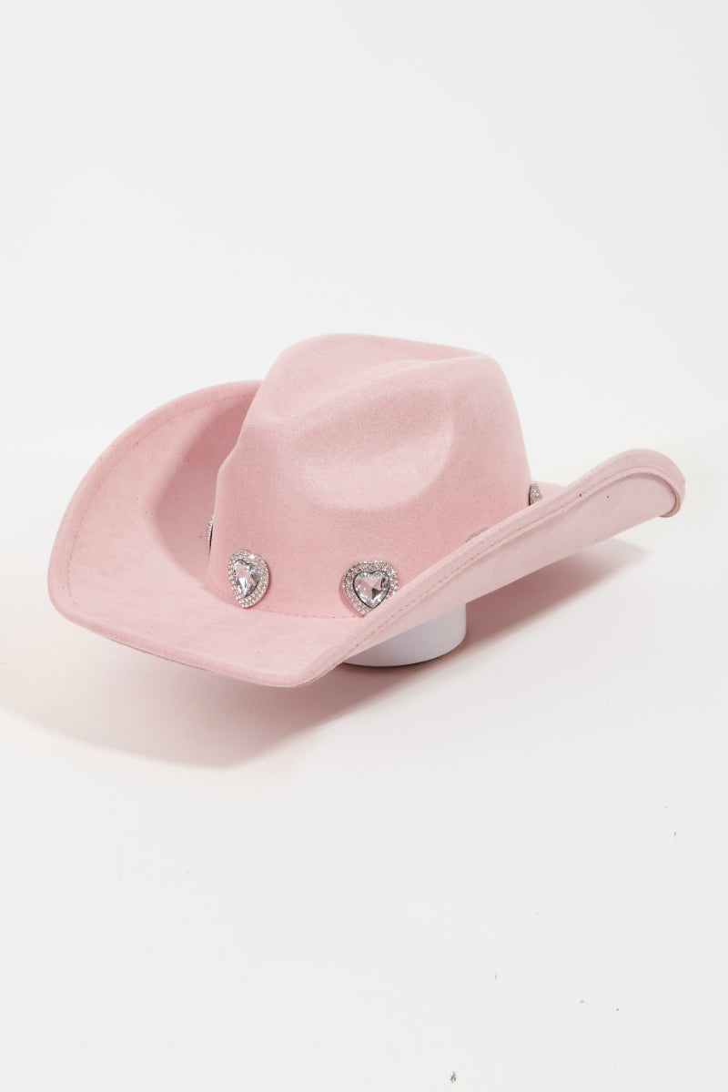 The Fame Rhinestone Pave Heart Cowboy Hat, a vibrant pink accessory made from durable polyester alloy, features three decorative silver embellishments on the front. It is showcased against a plain white background and includes an adjustable string to ensure a perfect fit for any head size.