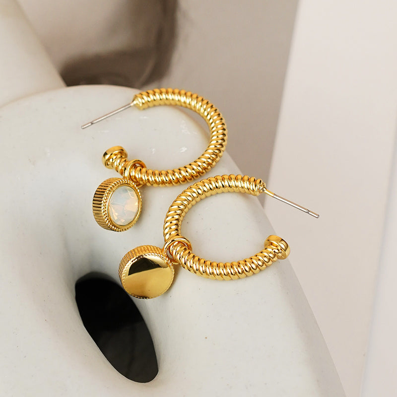 Introducing the Rope Cat's Eye Stone C-Hoop Earrings, featuring a gold-plated coiled design adorned with cat's eye gemstones near the clasps, set against a plain white background.