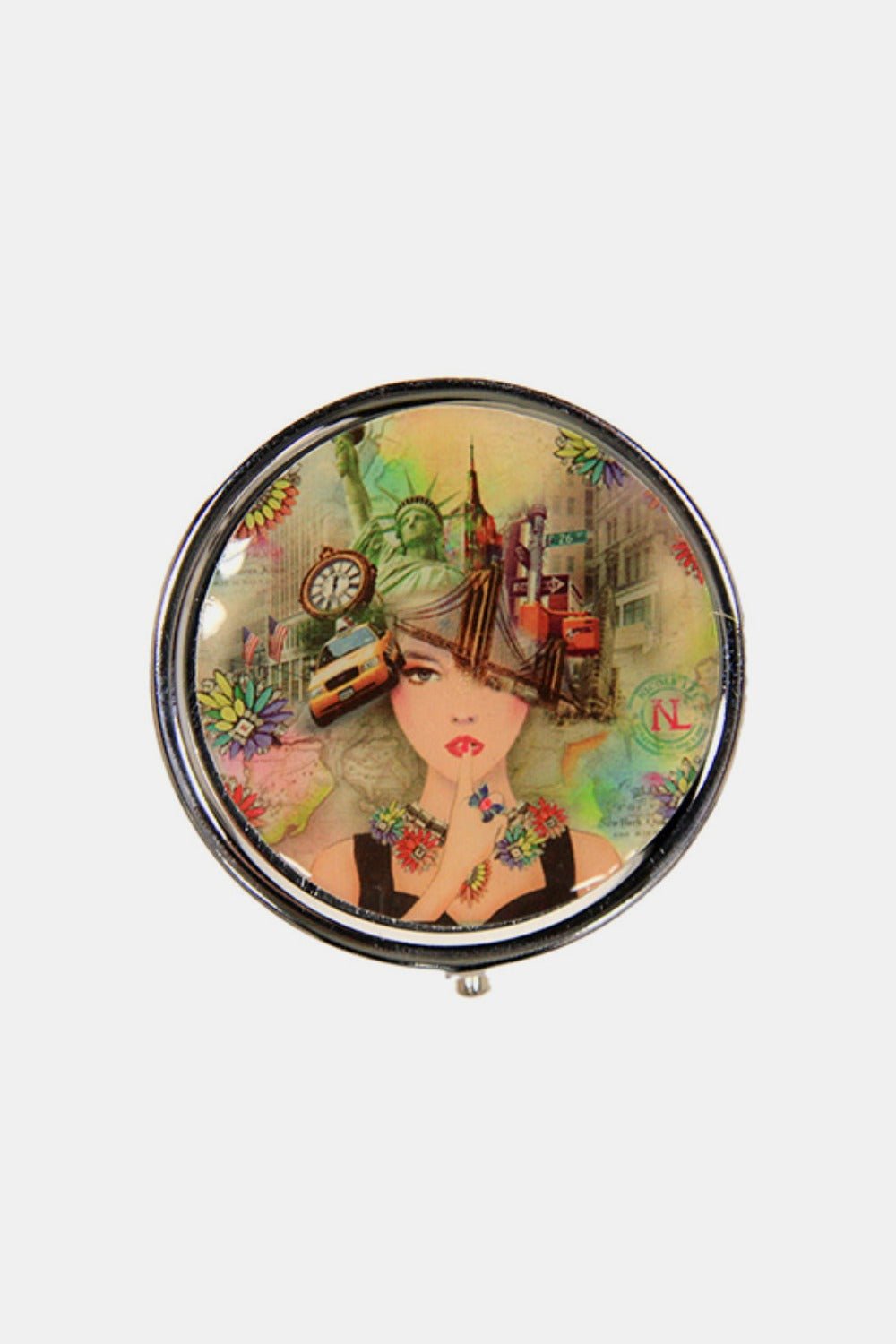 The Nicole Lee USA Print Metallic Circular Small Pill Case holds a metal pin that showcases an illustration of a dog and cat driving a red convertible through a city adorned with iconic buildings and landmarks, all wrapped in a sleek silver-tone metal exterior.