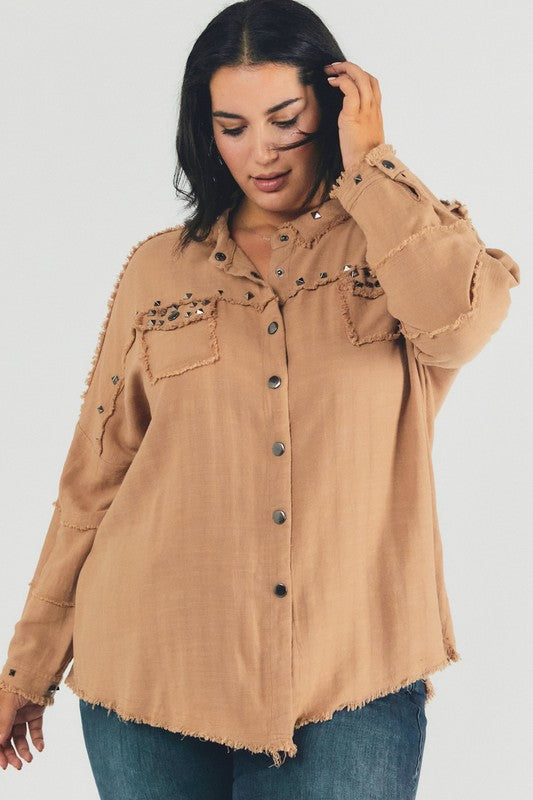 A person with dark hair wearing a Plus Distressed Hem Button Down Oversize Shirt and jeans stands against a light background, embodying casual comfort.