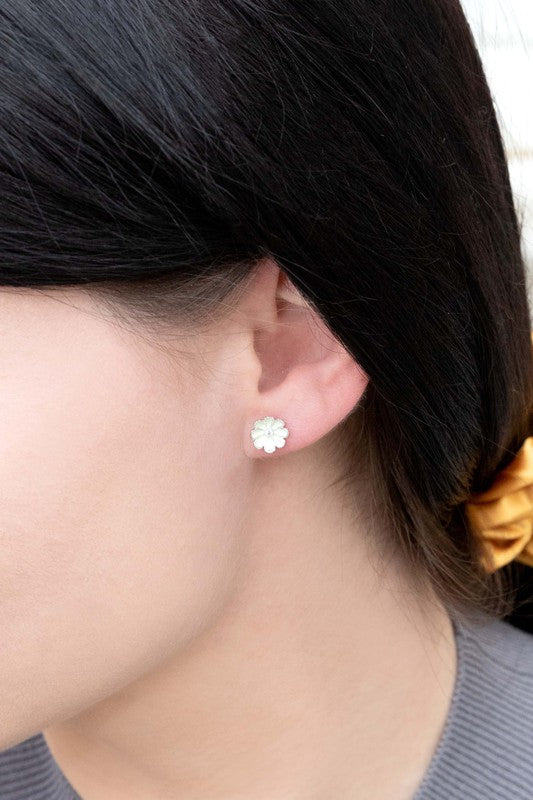 A pair of Primrose Stud Earrings on a white background.