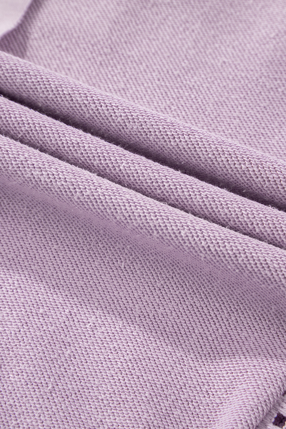 A person with long hair is seen from the back wearing the Orchid Petal Knit Crochet Exposed Seam Ribbed Trim Sweatshirt, blue jeans, and a brown crossbody bag.