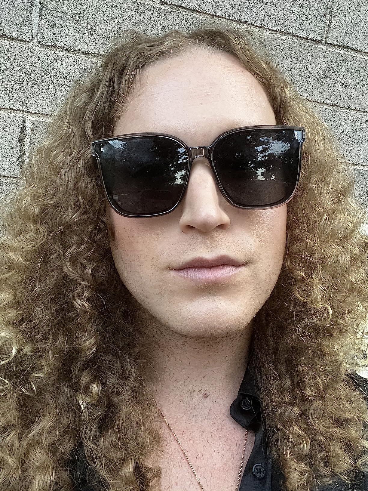 A pair of FEISEDY Women Oversized Vintage Polarized Sunglasses Square Cute Trendy Classic Simple Men B2758 with dark lenses and thin arms.