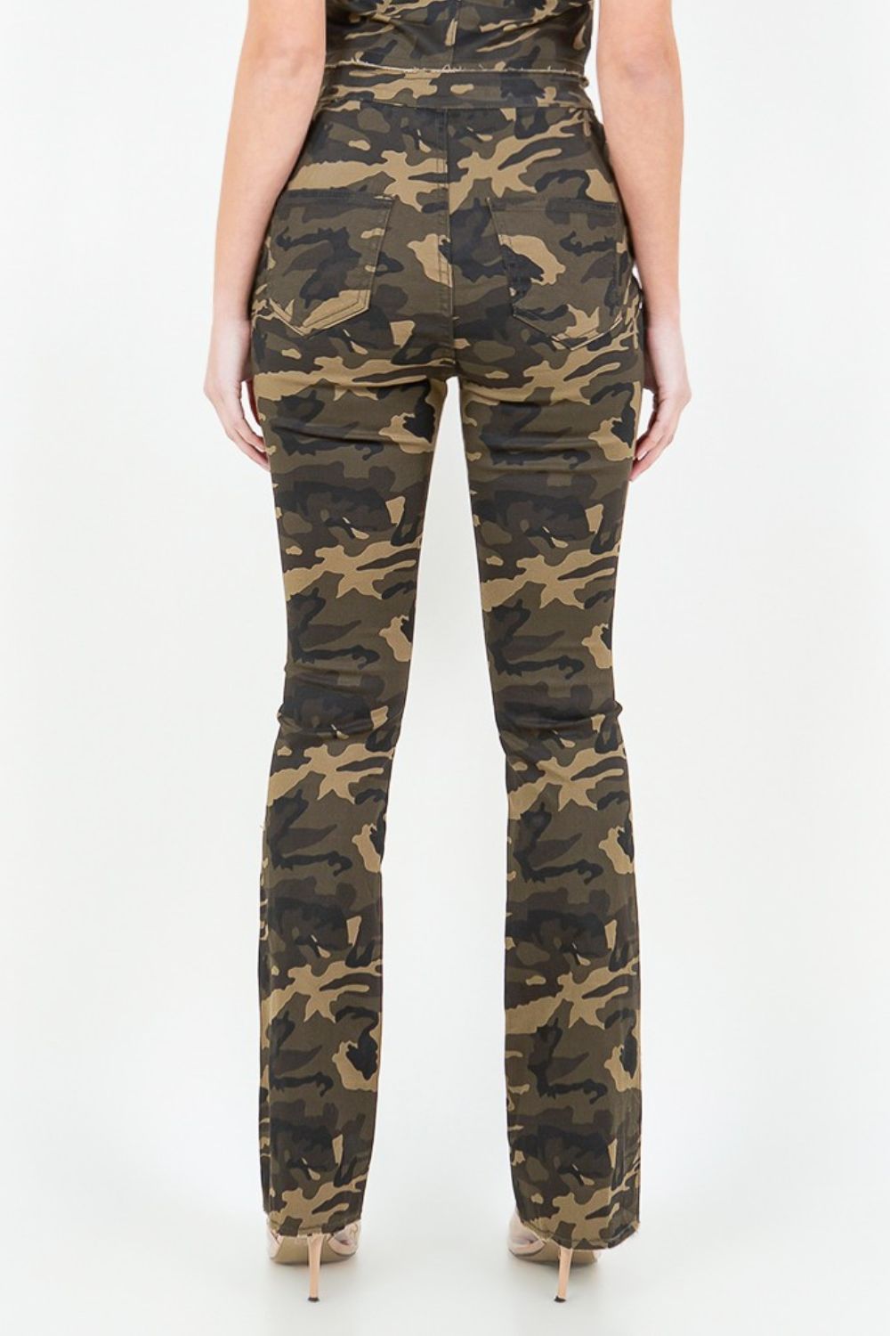 A person wearing a sleeveless camouflage top and fashion-forward American Bazi V-Cut Ruched Camo Flare Pants stands against a plain white background.