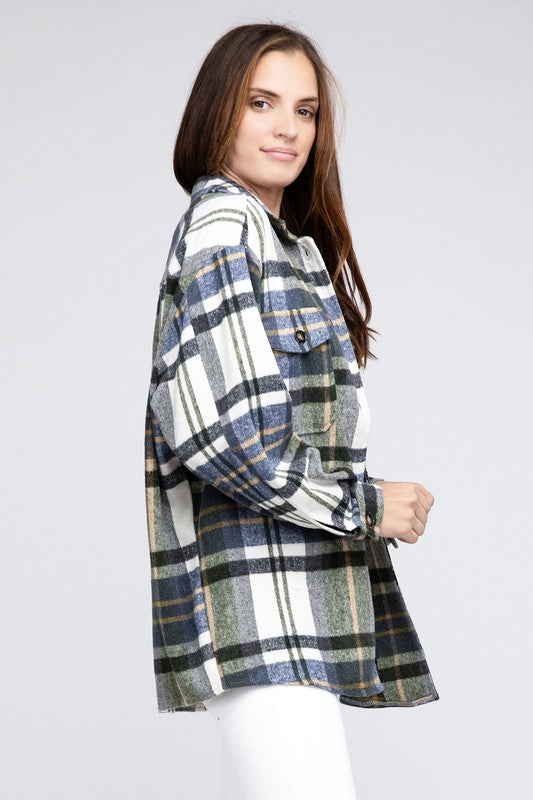 A woman smiles while wearing a Textured Shirt With Big Checkered Point, sitting near a window with greenery outside.