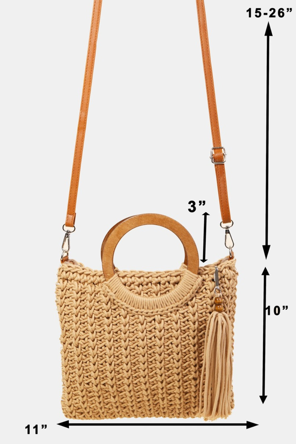 The Fame Crochet Knit Convertible Tote Bag includes a cream-colored design with round wooden handles and a matching tassel accent.