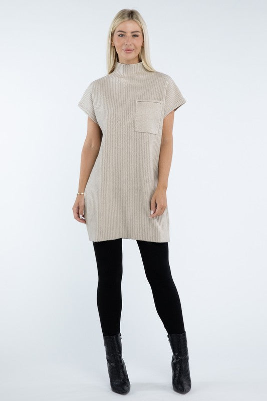 A woman stands wearing a brown Mock Neck Short Sleeve Sweater Dress with a pocket on the left side of the chest, paired with black ankle boots. She is posing against a plain white background.