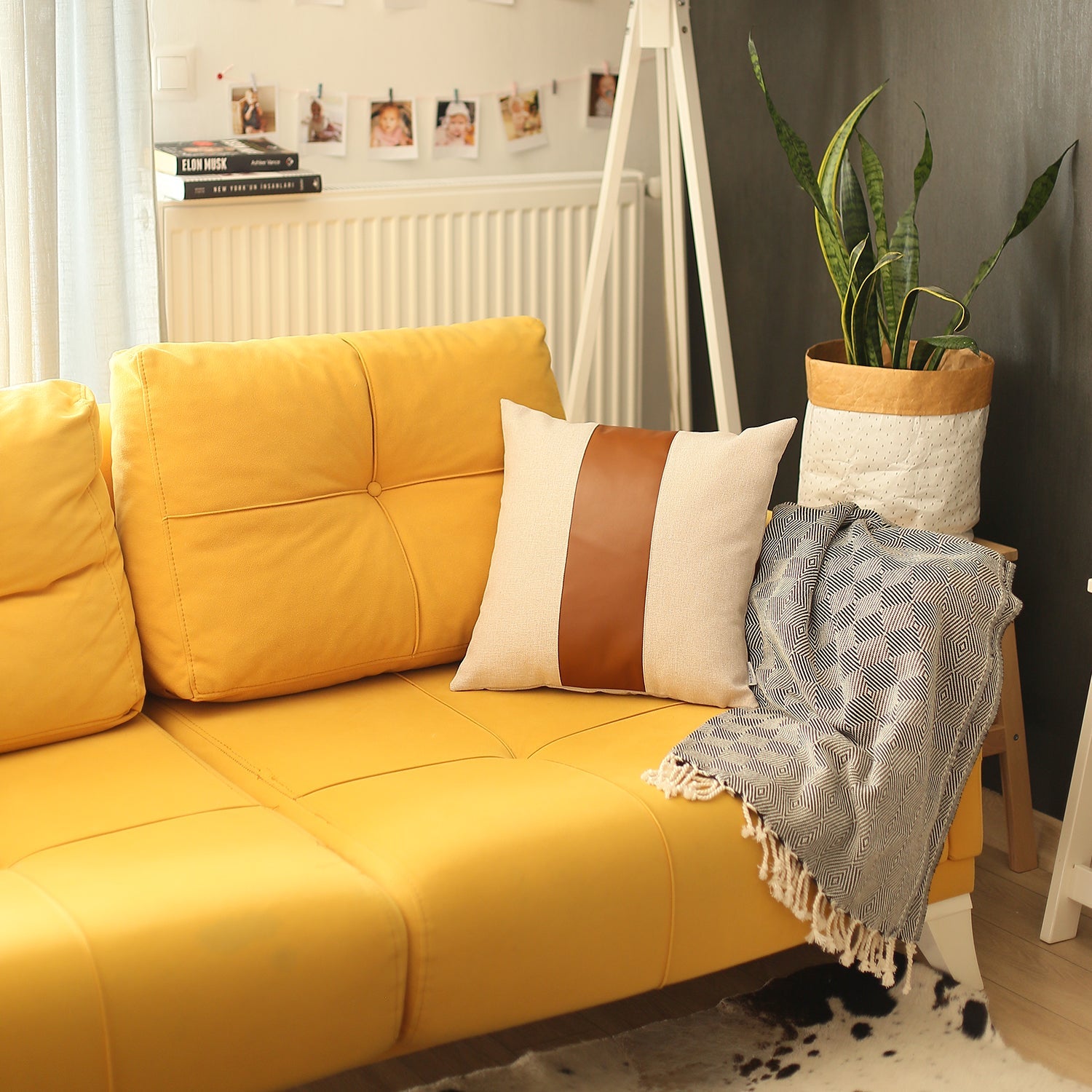 In a well-lit room, a black wire chair is tastefully adorned with a Boho Handcrafted Decorative Single Throw Pillow Cover in beige and brown, featuring vegan faux leather.