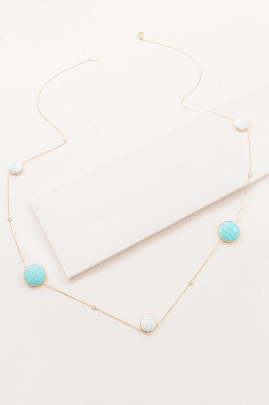 Boheme Stone Necklace with turquoise stone pendants on a white surface.