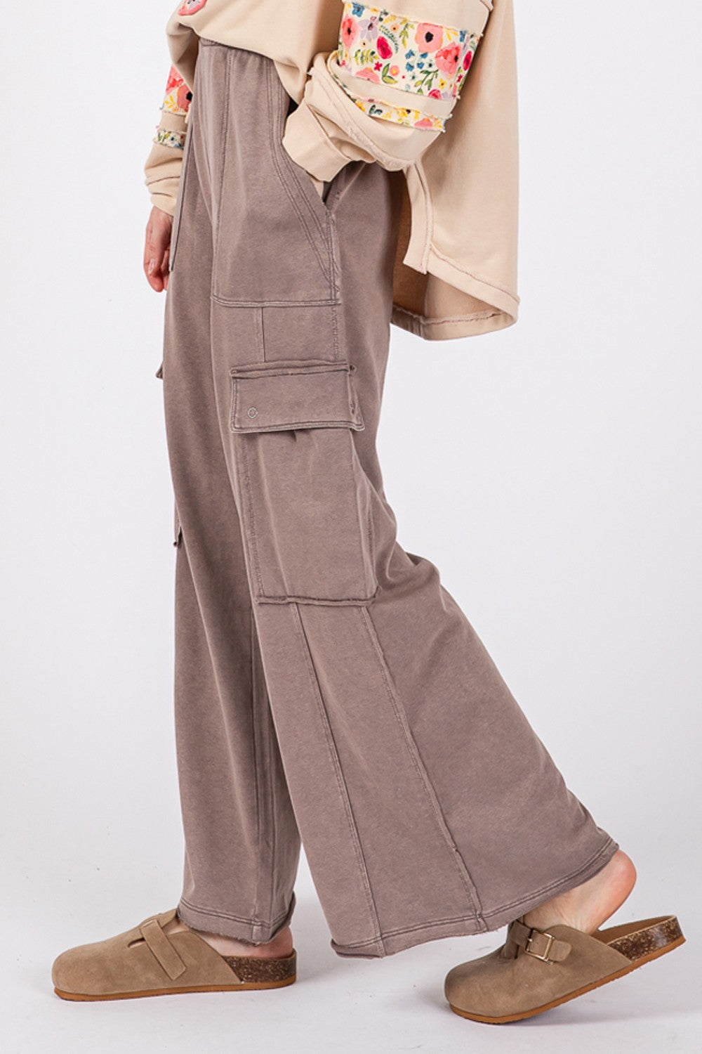 A person wearing SAGE + FIG Knit Terry Mineral Wash Wide Leg Pants in brown and beige shoes stands against a plain background.