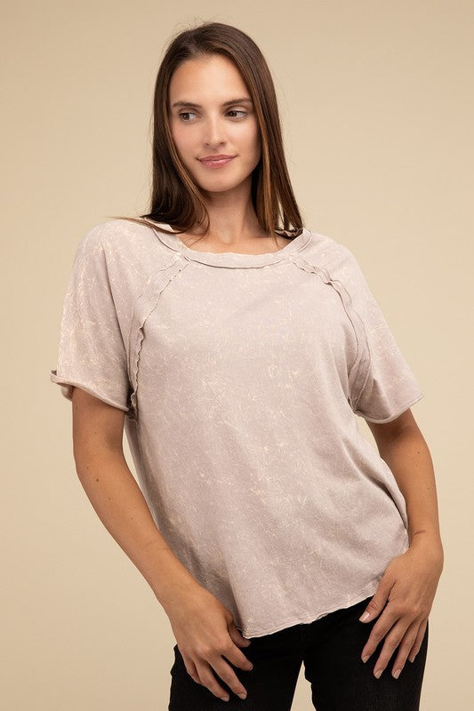 A person with long brown hair wearing a Back Patch Crinkle Washed Raglan Sleeve T-Shirt stands against a plain beige background.