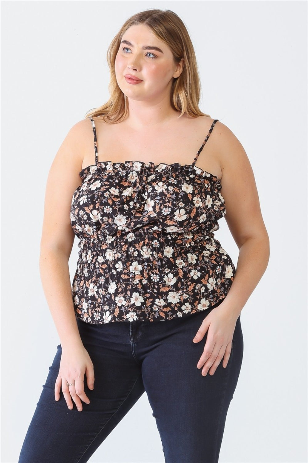 A person with long hair, wearing the Zenobia Plus Size Frill Floral Square Neck Cami and dark jeans, stands with one hand on their hip and the other relaxed by their side.