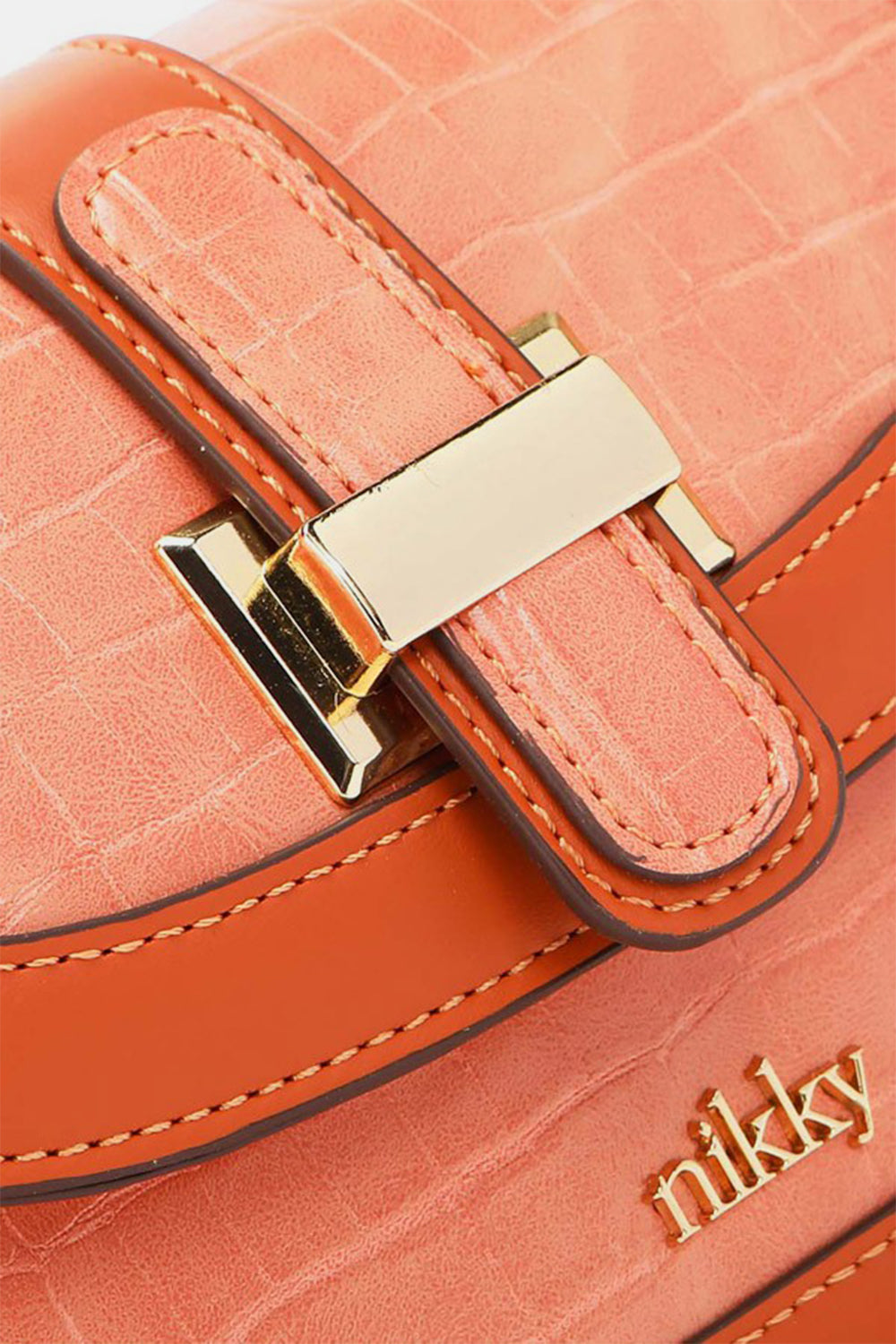 This stylish Nicole Lee USA croc embossed crossbody bag, crafted from eco-leather, features an orange hue, a gold buckle, and the brand name "nikky" on the front.