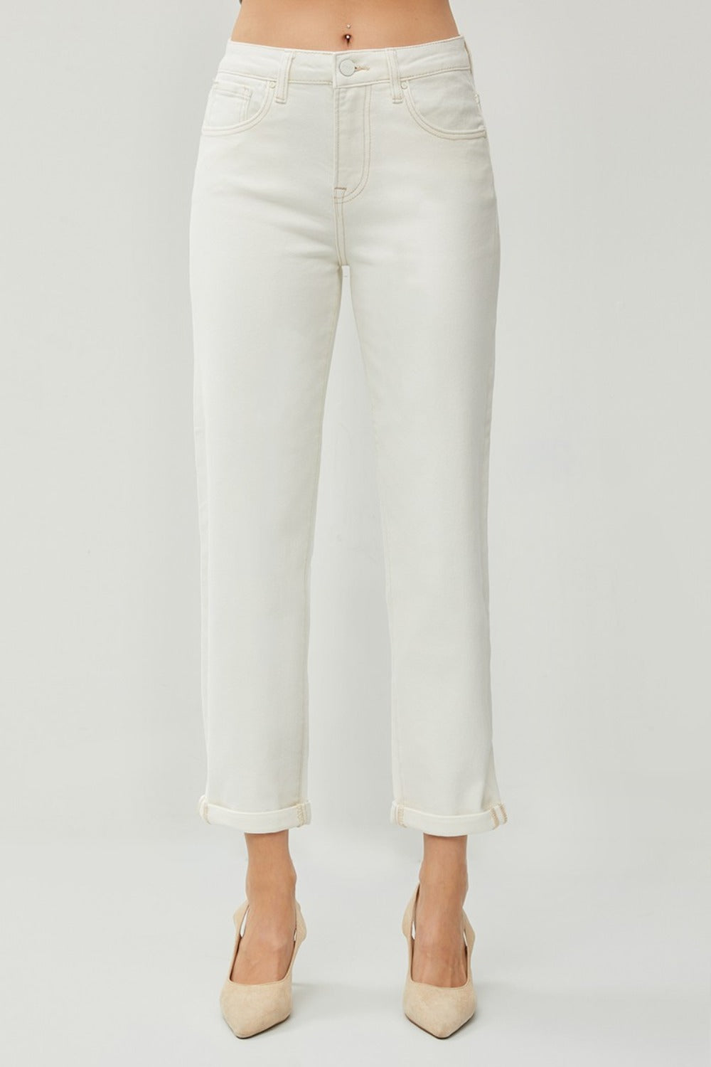 Description: Person wearing RISEN Full Size High Waist Rolled Hem Straight Jeans in white with beige heels against a plain background. 