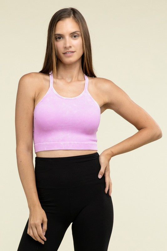 A person poses in a Washed Ribbed Seamless Cropped Cami Top with removable bra pads and black leggings against a neutral background.