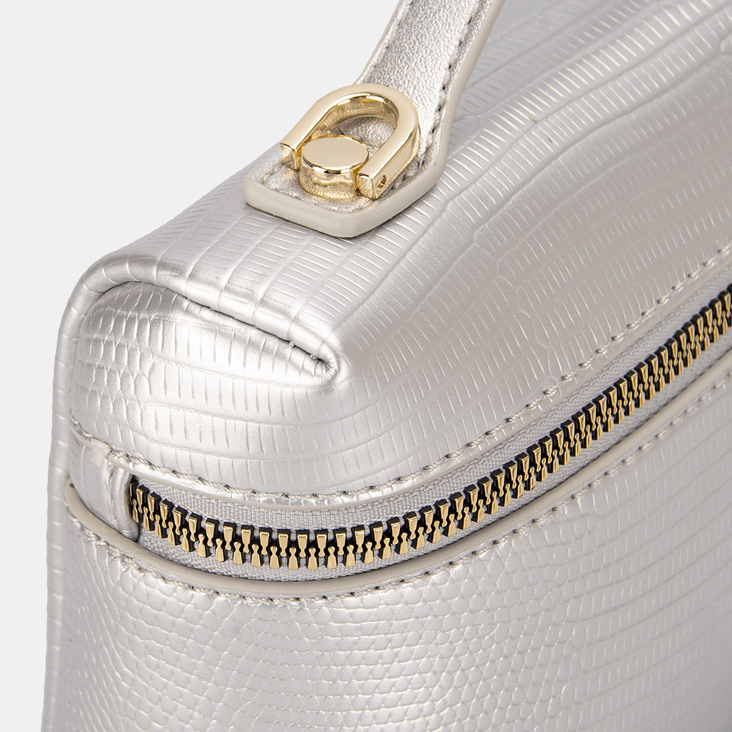 The David Jones Texture PU Leather Handbag is a cream-colored cosmetic bag featuring a convenient handle and is crafted from textured PU leather, complete with a gold zipper adorned with a small lock charm.