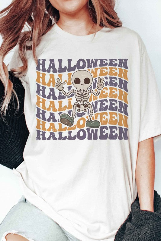 Person wearing the HALLOWEEN SKELETON Graphic Tee, which features a cartoon Halloween skeleton and the word "HALLOWEEN" repeated in orange and purple text.