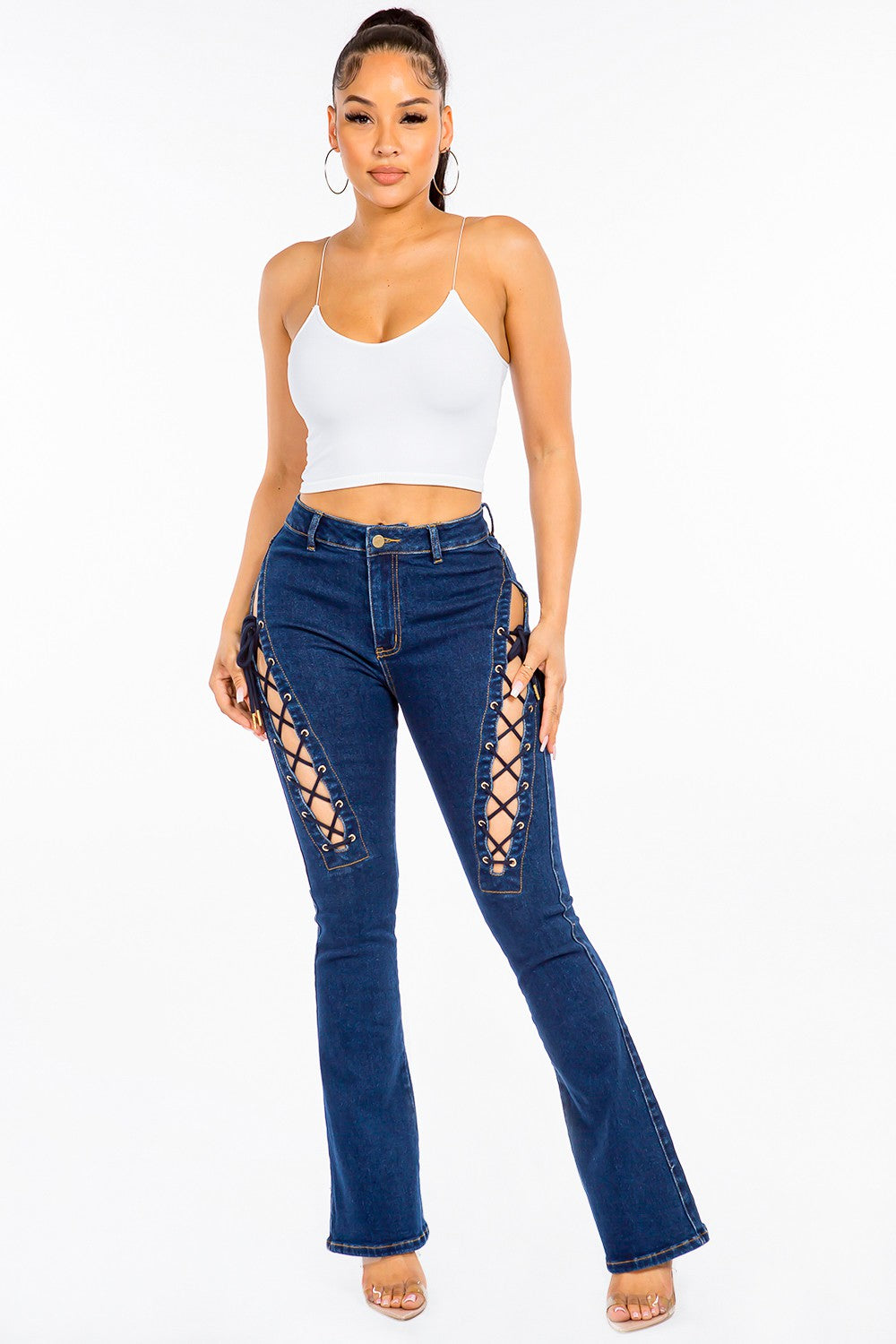 A pair of American Bazi High Rise Lace Up Jeans, featuring stylish denim and side detailing, worn by a person.