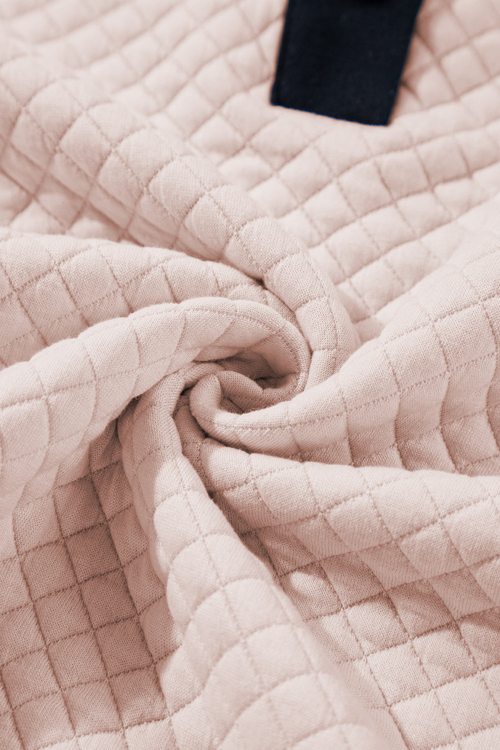 A person wearing an Oatmeal Textured Colorblock Edge Buttoned Collar Sweatshirt, paired with blue jeans, stands with their back to the camera against a white backdrop. The trendy sweatshirt features stylish textured fabric and buttoned collars that add an extra touch of sophistication.