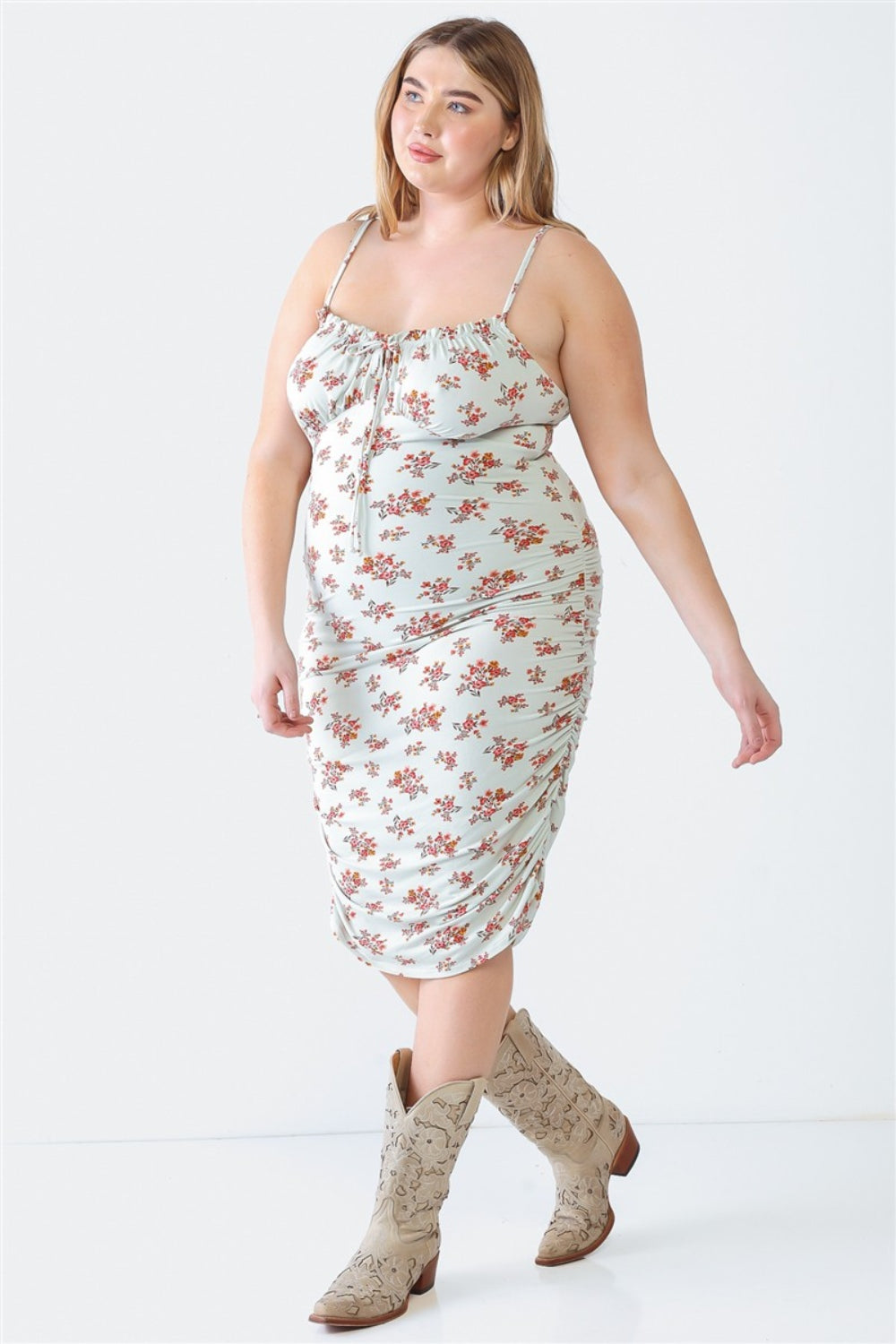 A woman stands against a white background wearing a Blue Leopard Plus Size Ruched Floral Square Neck Cami Dress with strappy high-heeled sandals, perfect for a summer day out.