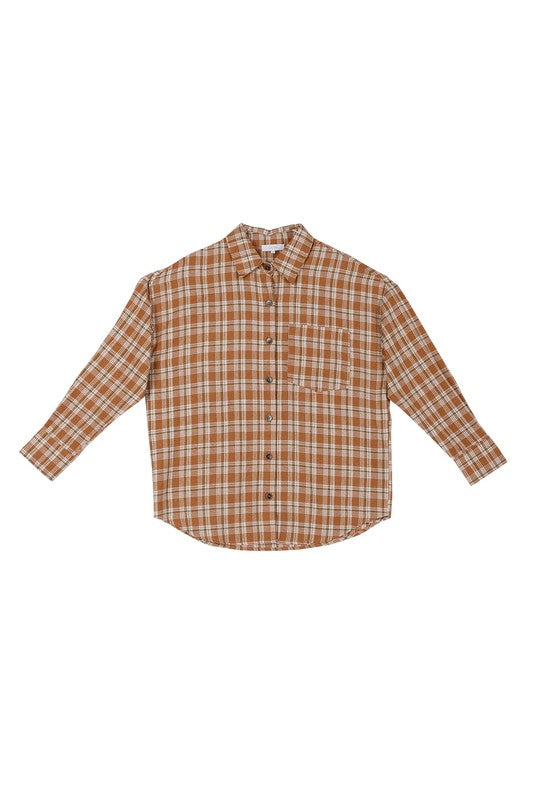 Wearing an Autumn beige plaid shirt, a person with long hair complements their look with hoop earrings, showcasing the season's warm hues. This long-sleeved shirt rests gracefully against a beige backdrop and is ideal for machine wash cold care.