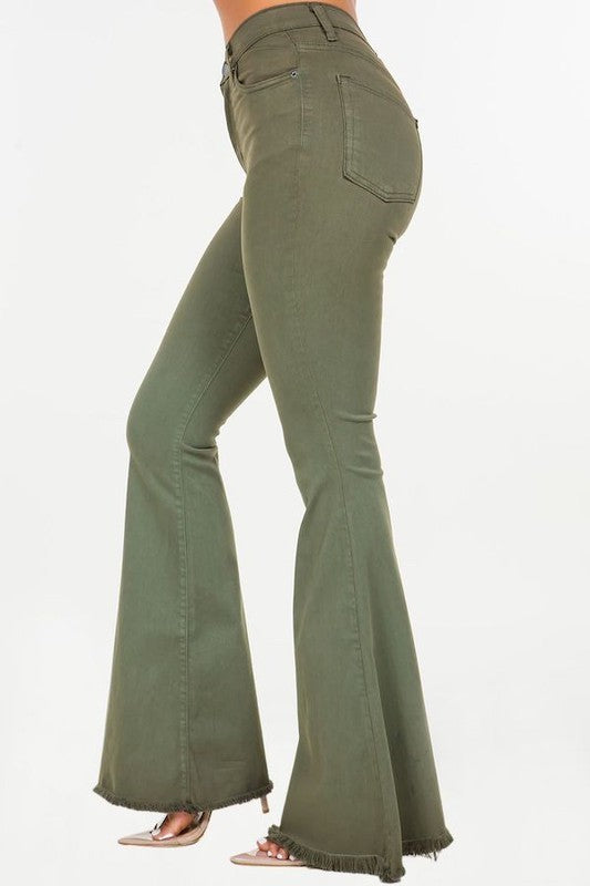 A person wearing the Bell Bottom Jean in Olive, high-rise pants with a 30" inseam, made in the USA, with their torso and feet partially visible against a plain background.